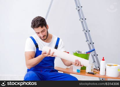 Repairman doing renovation repair in the house with paper wallpa. Repairman doing renovation repair in the house with paper wallpaper