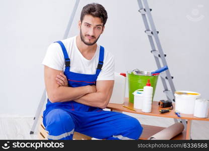 Repairman doing renovation repair in the house with paper wallpa. Repairman doing renovation repair in the house with paper wallpaper