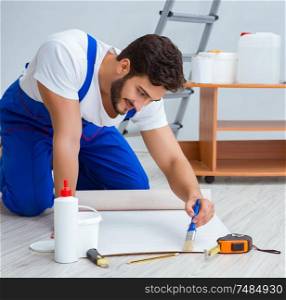 Repairman doing renovation repair in the house with paper wallpaper. Repairman doing renovation repair in the house with paper wallpa