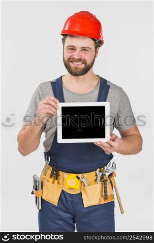 repairman overall holding tablet with blank screen