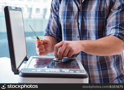 Repairman repairing broken color printer