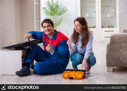 Repairman repairing tv at home