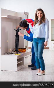 Repairman repairing tv at home