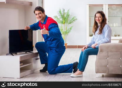 Repairman repairing tv at home