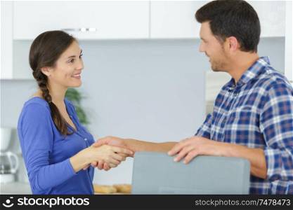 repairman shaking hands with female customer