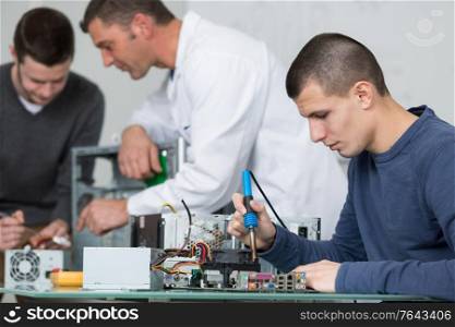 repairman soldering electronic components on cpu