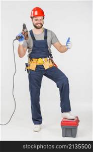 repairman with drill showing thumb up