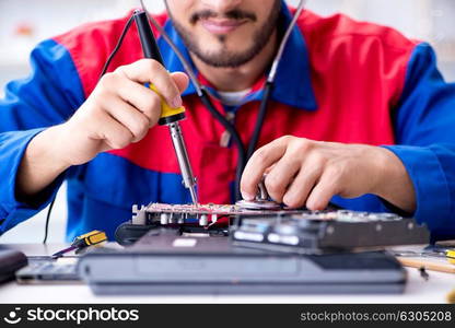 Repairman working in technical support fixing computer laptop tr. Repairman working in technical support fixing computer laptop troubleshooting