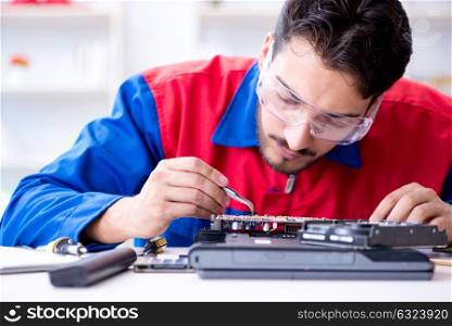 Repairman working in technical support fixing computer laptop tr. Repairman working in technical support fixing computer laptop troubleshooting