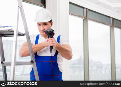 Repairman working with power drill in workshop