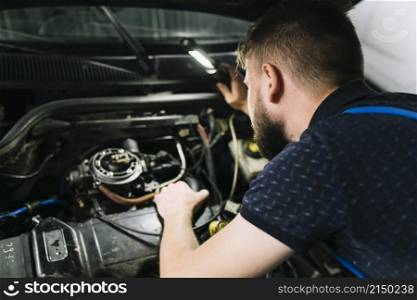 repairmen inspecting vehicle engine