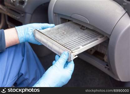 Replacing dirty cabin pollen air filter for a car