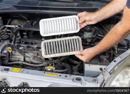 Replacing the dirty engine air filter for a car