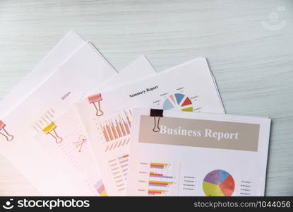 Report paper document present financial and business report graph chart on office table background