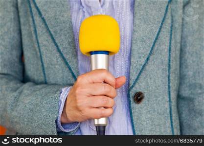 Reporter holding microphone. Media reporting. Journalism.