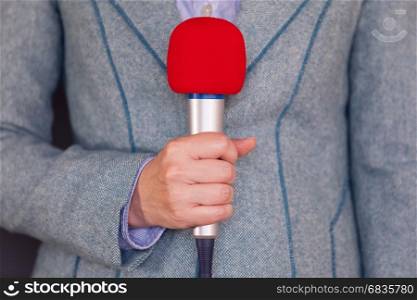 Reporter holding microphone. Press reporting. News.