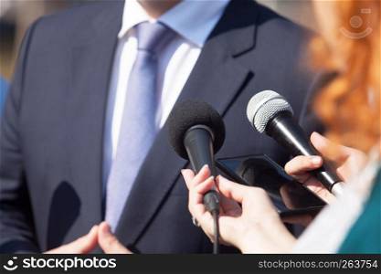 Reporters making press interview with politician or businessman