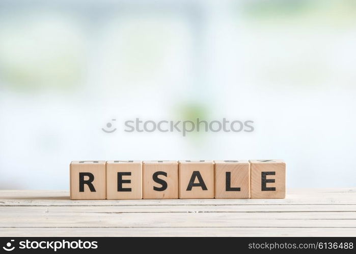 Resale sign made of cubes on a wooden desk