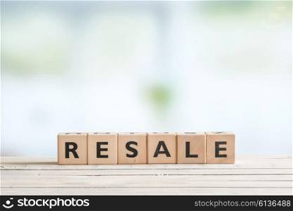 Resale sign made of cubes on a wooden desk
