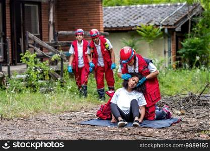 Rescue team helping injured female victim 