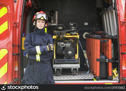 Rescue worker standing by open back door of rescue vehicle