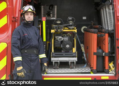 Rescue worker standing by open back door of rescue vehicle