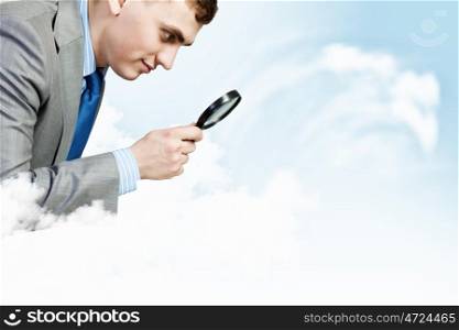 Research and analysis. Image of businessman looking in magnifying glass