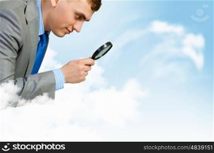 Research and analysis. Image of businessman looking in magnifying glass