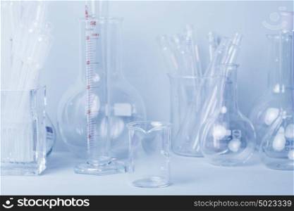 Research lab assorted glassware equipment in blue tone