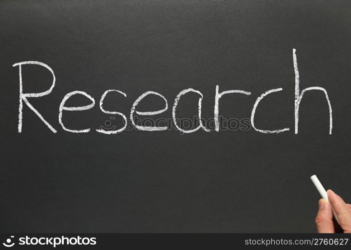 Research, written on a blackboard.