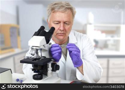 Researcher in the lab looking on microscope slide
