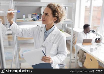 researcher with clipboard biotechnology laboratory