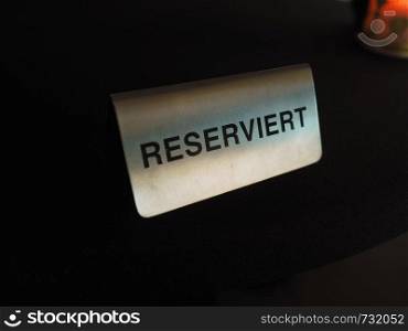 Reserviert (meaning Reserved in German) sign on a restaurant table. Reserviert (reserved) table sign