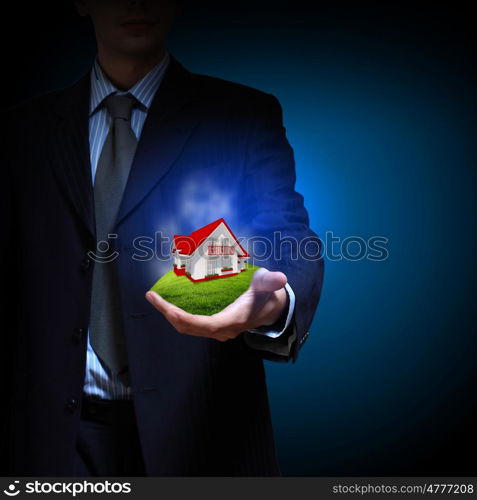 Residential building. Residential building and a businessman holding it in his hands