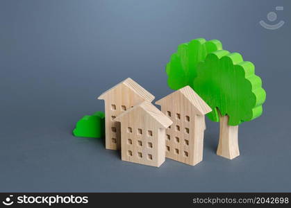 Residential buildings among the trees. Environmentally friendly, energy efficiency, zero carbon emissions. Buying and selling real estate. Renting housing, realtor services. Carbon neutrality.