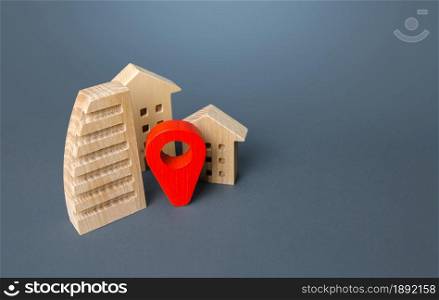 Residential buildings and a red location pin. Location, accessibility and proximity to infrastructure. Visit the town. Search for housing options. City navigation, orienteering. Realtor service agency