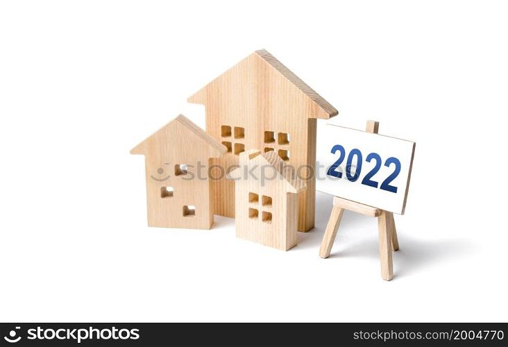 Residential buildings and easel 2022. Concept of real estate market in new year. Housing market predictions, trends and tendencies. Investment plans. Mortgage loan. Economic analysis. Home loans