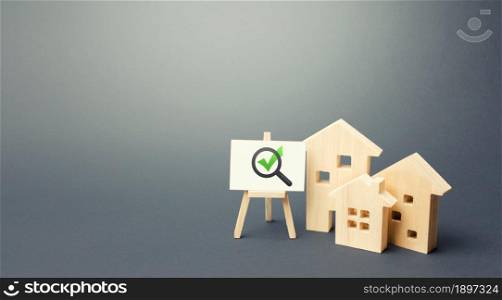 Residential buildings and easel with magnifying glass and green check mark. Compliance of housing with the necessary criteria and quality standards. Search for real estate to buy. Realtor services.