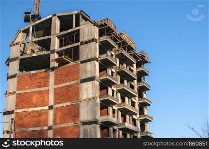 Residential contemporary building under construction in sunny day
