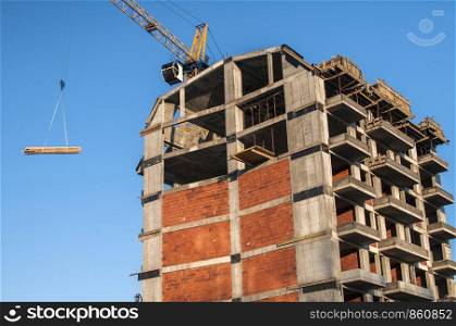Residential contemporary building under construction in sunny day