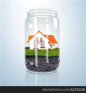 Residential house with red roof inside glass jar