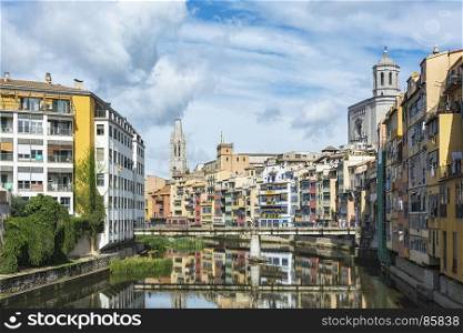 Residential houses along the river Onyar with a view of the sights in the city of Girona (Spain, Catalonia)