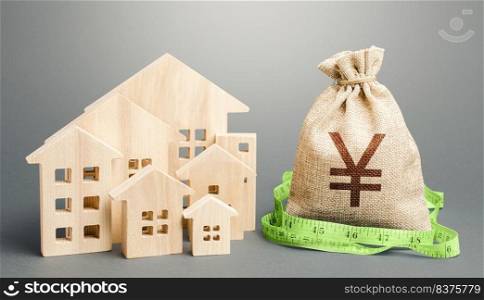 Residential houses and a Yen Yuan money bag. Buying, fair price. City municipal budget. Property real estate valuation. Mortgage loan. Calculation of construction and repair expenses