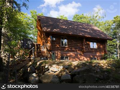 Residential log home in summertime, Quebec, Canada