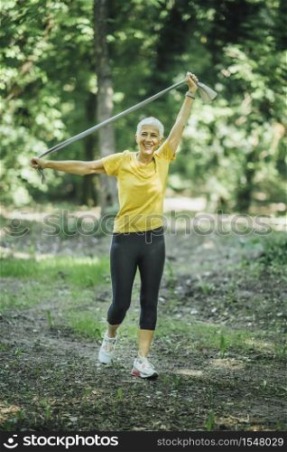 Resistance band walking exercise. Mature woman doing strength workout with elastic resistance band . Resistance Band Walking Exercise