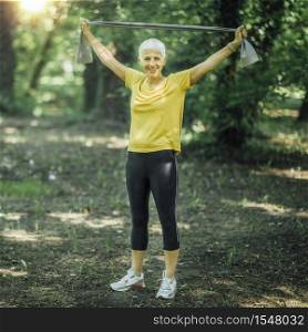 Resistance band walking exercise. Mature woman doing strength workout with elastic resistance band . Resistance Band Walking Exercise