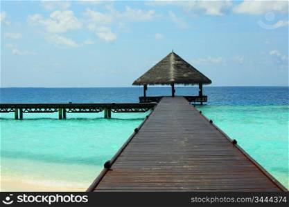 resort maldivian houses in blue sea