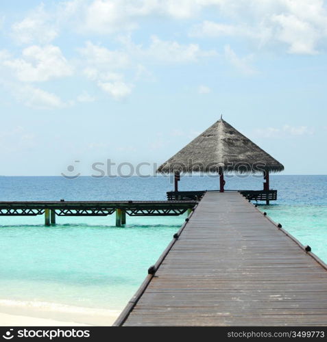 resort maldivian houses in blue sea