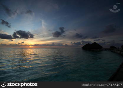 resort maldivian houses on sunrise