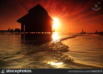 resort maldivian houses on sunrise